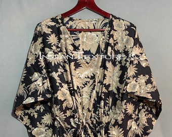 May include: A black and gold floral print kaftan with a V-neck and a drawstring waist.