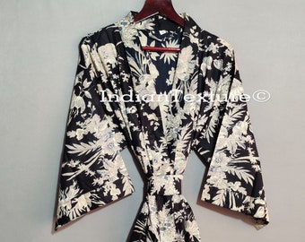 May include: A black and white floral print kimono robe with a long sleeve and a sash tie.