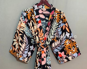 May include: A black floral print kimono robe with a tie belt. The robe has a colorful floral pattern with orange, pink, blue, and green leaves and flowers.