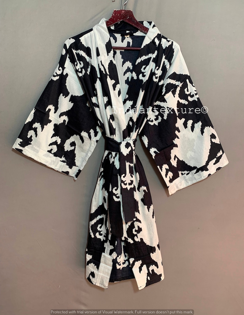 May include: Black and white patterned cotton robe with a tie belt. The robe has a traditional Japanese kimono style. The text "Indiantexture&copy;" is visible on the robe.