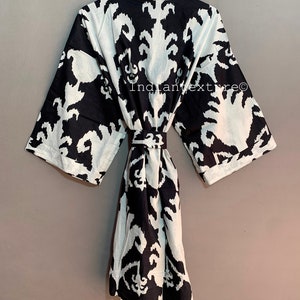 May include: Black and white patterned robe with a tie belt. The robe has a traditional Japanese style.