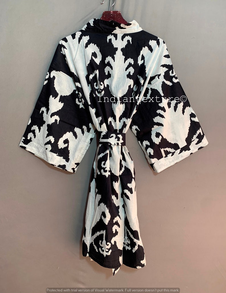 May include: Black and white patterned robe with a tie belt. The robe has a traditional Japanese style.