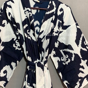 May include: A black and white patterned cotton robe with a long sleeve and a tie belt. The robe has a V-neck and is made of a soft, comfortable fabric.