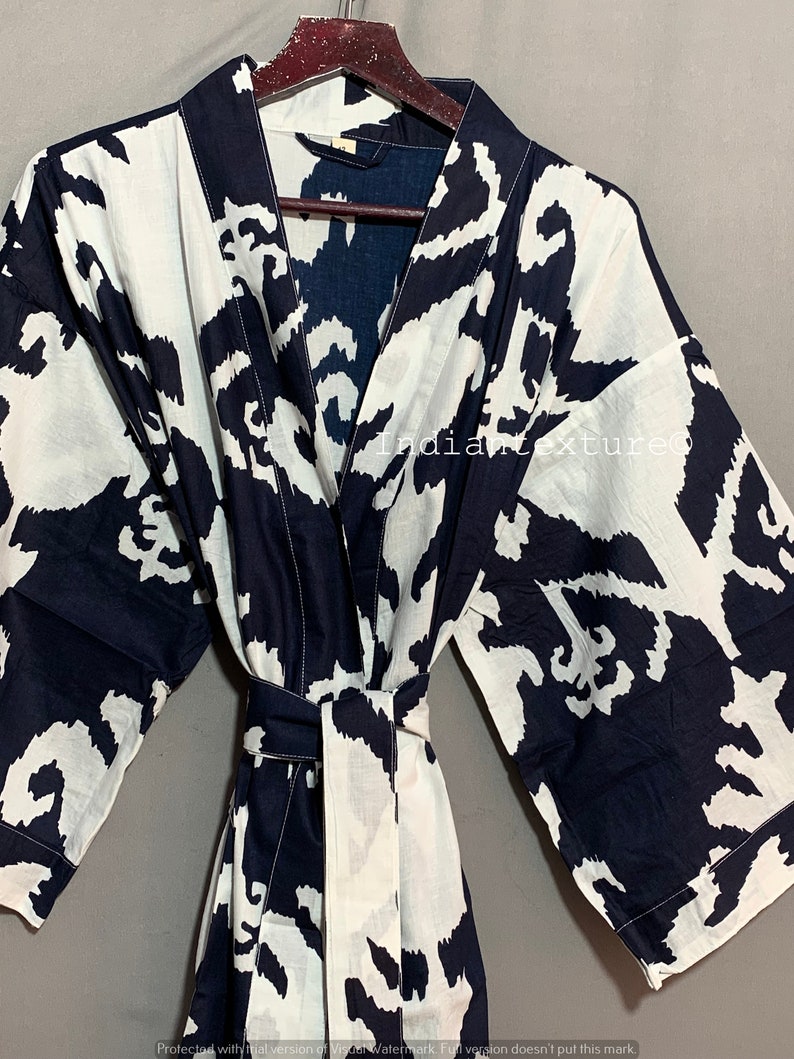 May include: A black and white patterned cotton robe with a long sleeve and a tie belt. The robe has a V-neck and is made of a soft, comfortable fabric.