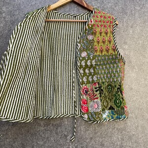 May include: A green and white striped quilted waistcoat with a patchwork design on the right side. The patchwork features floral and geometric patterns in shades of green, pink, and yellow.