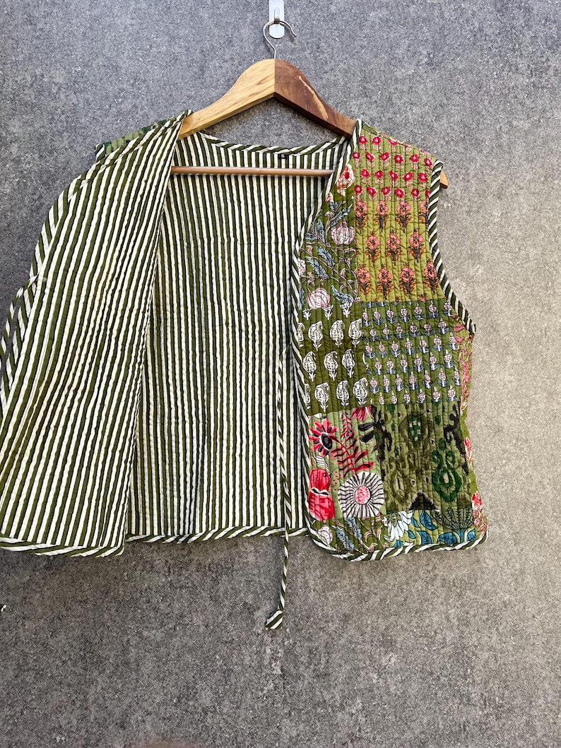 May include: A green and white striped quilted waistcoat with a patchwork design on the right side. The patchwork features floral and geometric patterns in shades of green, pink, and yellow.