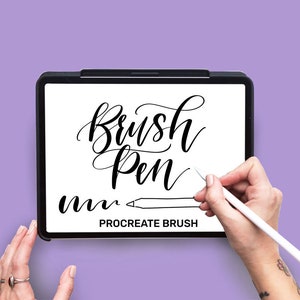 May include: A digital tablet displaying the text "Brush Pen" in black cursive lettering. The text "Procreate Brush" is also visible on the screen. A hand is holding a white stylus and drawing on the tablet.