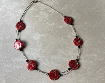 Necklace with floral patterned CAM DISCS