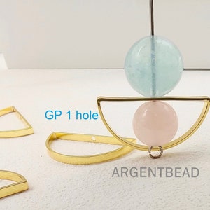 May include: Gold-toned metal half-circle frames with a single hole. The frames are shown with a light blue and a pink round bead. The text "GP 1 hole" and "ARGENTBEAD" are visible in the image.
