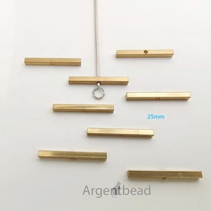 May include: A collection of brass bar components, each approximately 1 inch long, arranged on a white surface. The bars have a rectangular shape with a small hole drilled through them. The text "25mm" is visible, indicating the length of the bars.