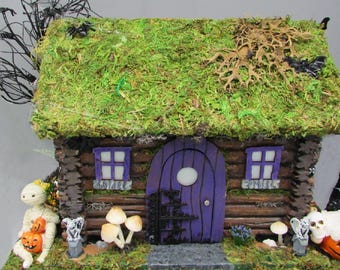 A Lighted Indoor Halloween Spooky House with a Halloween Gnome and Mummy