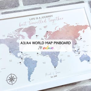 May include: A framed world map pinboard with a white frame. The map features a colour palette of blues, pinks, and purples, with black pins. The text "Life is a Journey, best travelled together" is displayed. The text "A3/A4 WORLD MAP PINBOARD 24 colours" is also visible.