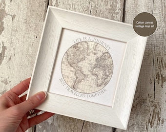 May include: White framed canvas print with a vintage world map and the text "Life is a journey best travelled together".