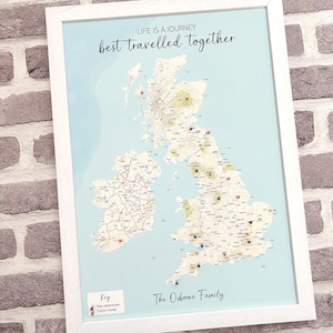 May include: Framed map of the UK with pins marking locations, set against a light blue background and framed in white. Text at the top reads "LIFE IS A JOURNEY best travelled together." The bottom text says "The Osborne Family."