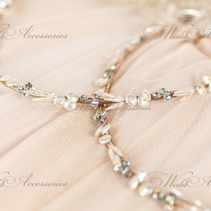 May include: A delicate bridal headpiece with a floral design. The headpiece features small white pearls, clear crystals, and a gold-toned wire base. The text "Wedd Accessories" is visible in the image.
