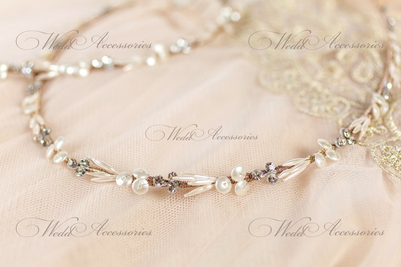 May include: A delicate bridal headband featuring faux pearls, clear crystals, and small, elongated beads. The design is accented with a thin, gold-toned wire. The text "Wedd Accessories" is visible.