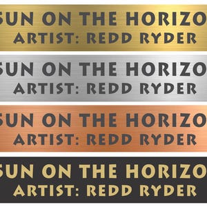 May include: Four rectangular metal plaques with a brushed finish in gold, silver, copper, and black. Each plaque features the engraved text SUN ON THE HORIZON and ARTIST: REDD RYDER in a bold, sans-serif font, centered on the horizontal surface.