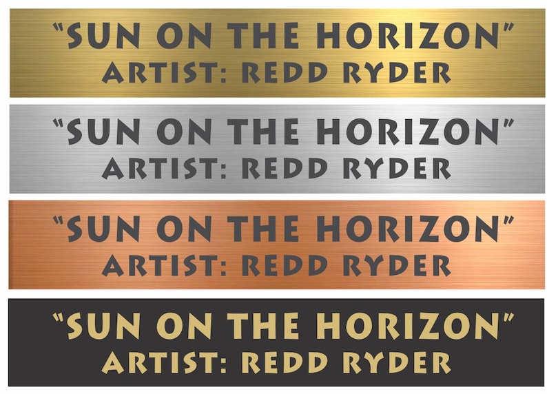 May include: Four rectangular metal plaques with a brushed finish in gold, silver, copper, and black. Each plaque features the engraved text SUN ON THE HORIZON and ARTIST: REDD RYDER in a bold, sans-serif font, centered on the horizontal surface.