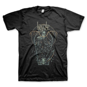 May include: Black t-shirt with a graphic of a skeleton in a coffin with wings. The text "Lamb of God" is above the graphic.