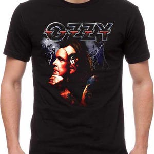 May include: A set of three ceramic mugs with a speckled, matte finish. The mugs are in shades of cream, light gray, and dark gray. Each mug has a simple, minimalist design and a rounded handle.