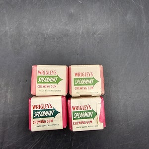 May include: Four vintage packs of Wrigley's Spearmint chewing gum. The packs are red with white lettering and a green spear mint leaf design.