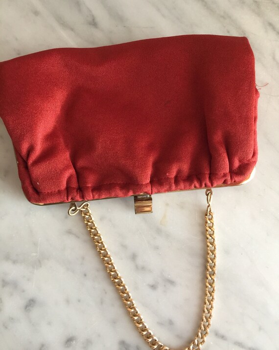 red purse with gold chain