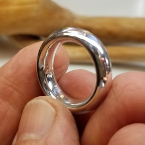 May include: A silver ring with a smooth, rounded surface. The ring is marked with the number "925" on the inside.