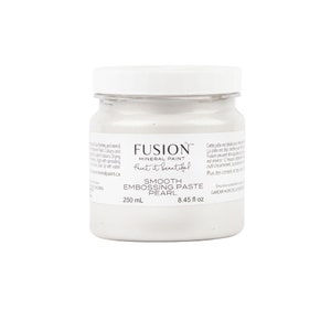 May include: A white jar of Fusion Mineral Paint Smooth Embossing Paste in Pearl. The jar is labeled with the product name, size (250 ml / 8.45 fl oz), and instructions to keep out of reach of children.