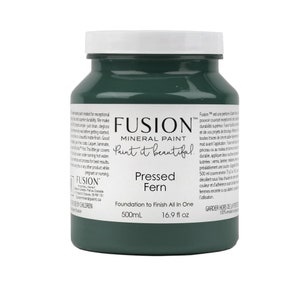 May include: A green 16.9 fluid ounce bottle of Fusion Mineral Paint in the color Pressed Fern. The bottle is labeled "Foundation to Finish All In One".