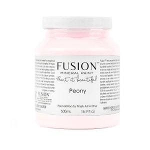 May include: A pink, 16.9 fluid ounce bottle of Fusion Mineral Paint in the color Peony. The bottle label reads "Foundation to Finish All In One" and "Paint it beautiful."