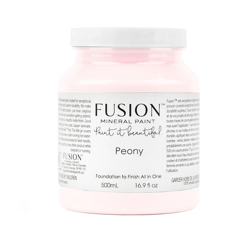 May include: A pink, 16.9 fluid ounce bottle of Fusion Mineral Paint in the color Peony. The bottle label reads "Foundation to Finish All In One" and "Paint it beautiful."