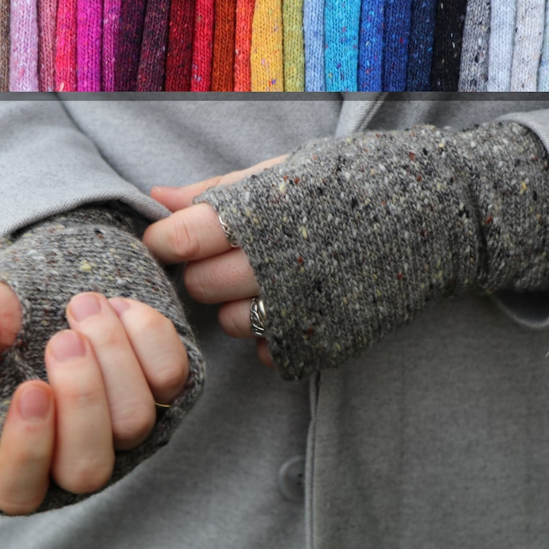May include: Gray fingerless gloves with a speckled pattern. The gloves are made of a knitted material and are shown against a gray background. A color palette of yarn samples is displayed above the gloves.