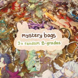 May include: A selection of colourful anime-style character acrylic charms. The image shows various designs, with the text "mystery bags" and "3 x random B-grades" overlaid. The charms are attached to keychains.