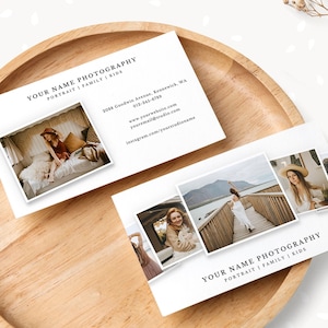 May include: Business cards with the text "YOUR NAME PHOTOGRAPHY PORTRAIT | FAMILY | KIDS" and sample photos. The cards are on a wooden tray with dried flowers. The cards also include contact information.