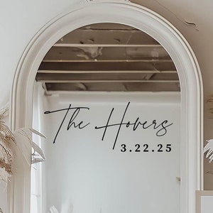 May include: A white arched mirror with a black inscription that reads "The Hovers 3.22.25".