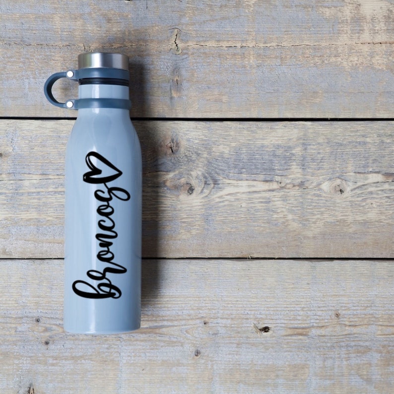 May include: A gray stainless steel water bottle with a black heart and the word "Broncos" written in cursive.
