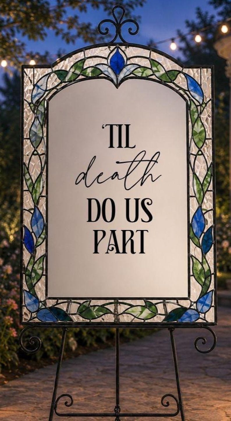 May include: A rectangular sign with a white center panel featuring the black text 'TIL death DO US PART'. The sign is framed by a decorative border of stained glass in shades of blue and green, set within a black metal frame with a scrollwork top.