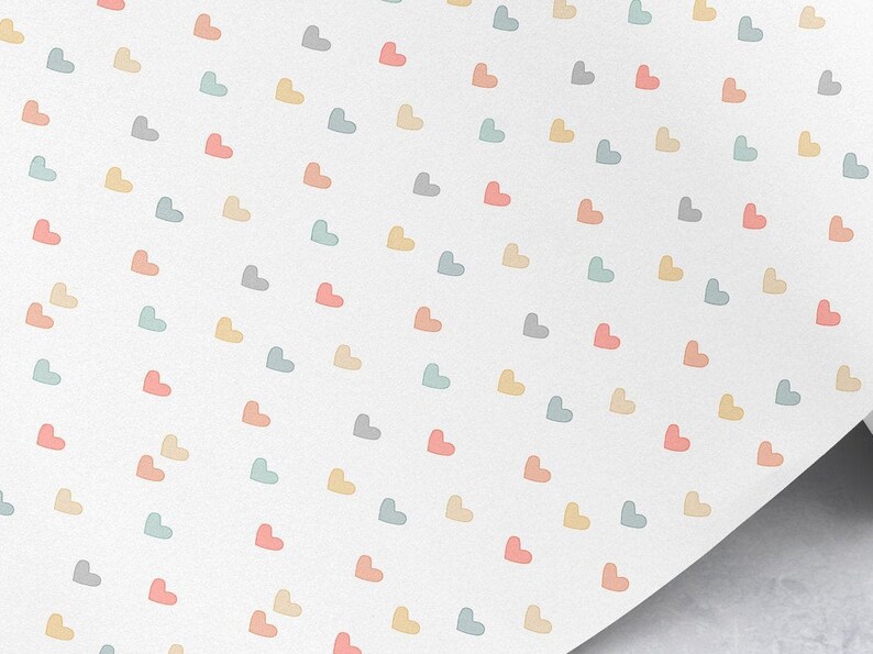 May include: A white background with a repeating pattern of pastel colored hearts. The hearts are in shades of pink, blue, yellow, and gray.