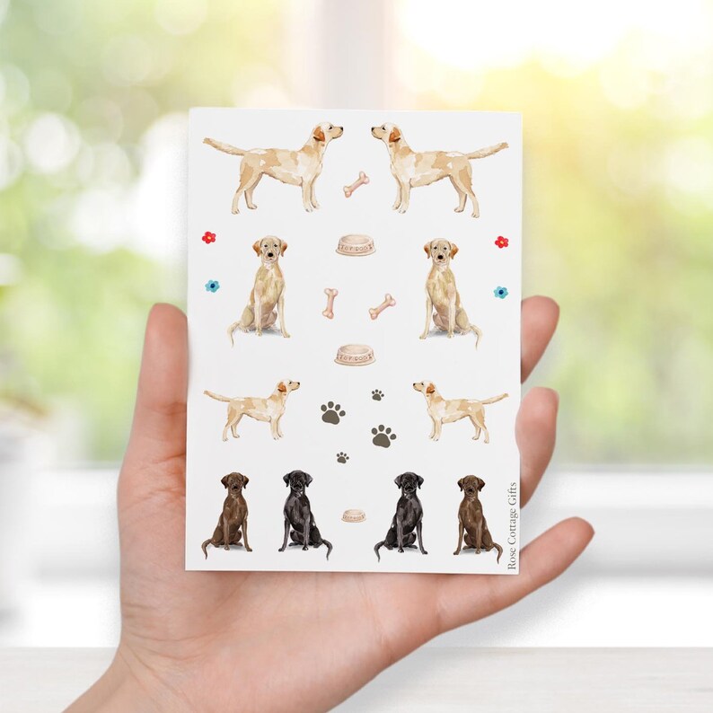 May include: A sheet of stickers featuring watercolor illustrations of Labrador Retrievers in both yellow and chocolate brown. The stickers include various dog-related icons such as bones, paw prints, and food bowls.