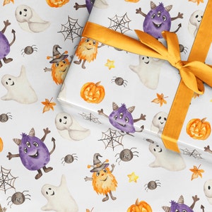 May include: White wrapping paper with a Halloween theme. The paper features a repeating pattern of ghosts, pumpkins, spiders, and monsters. The paper is tied with a yellow ribbon.