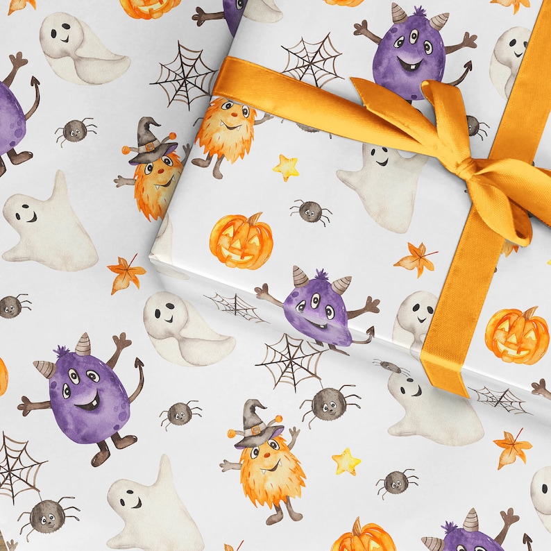 May include: White wrapping paper with a Halloween theme. The paper features a repeating pattern of ghosts, pumpkins, spiders, and monsters. The paper is tied with a yellow ribbon.