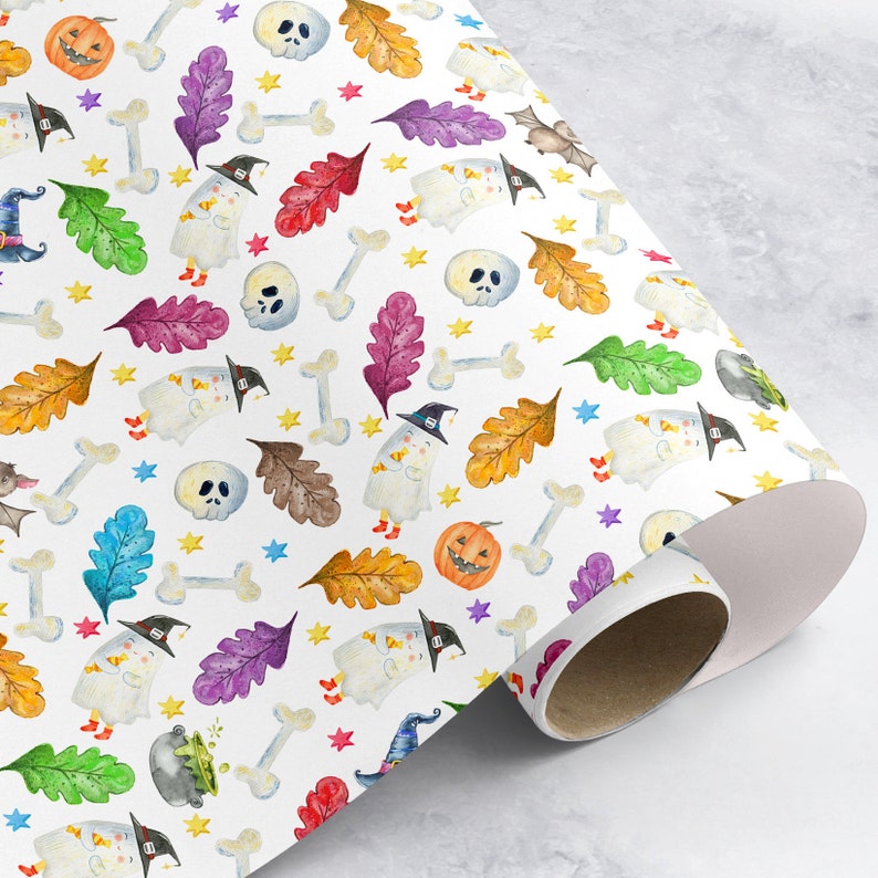 May include: White wrapping paper with a Halloween theme. The paper features a repeating pattern of ghosts, pumpkins, bats, bones, stars, and leaves in various colors, including orange, green, purple, and yellow.