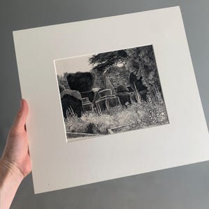 May include: Black and white art print depicting a garden scene with sculpted hedges and trees. The artwork is mounted and framed with a white border. The print uses detailed shading and texture, creating a realistic representation of the outdoor scene.