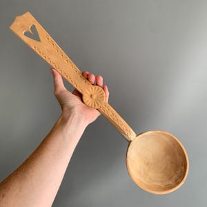 large hand carved wooden spoon
