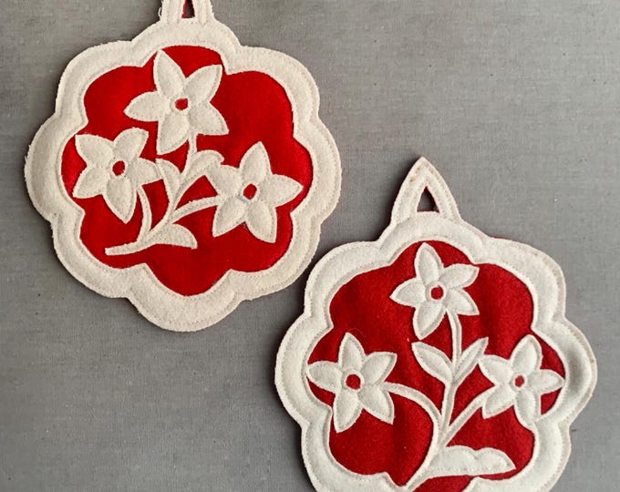 wool felt appliqued candle mats / coasters with a floral design.