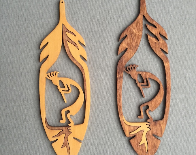 Kokopelli within a feather wooden hanging ornament