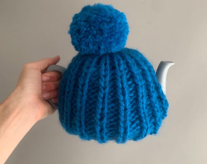 hand knitted tea cosy and ceramic tea pot
