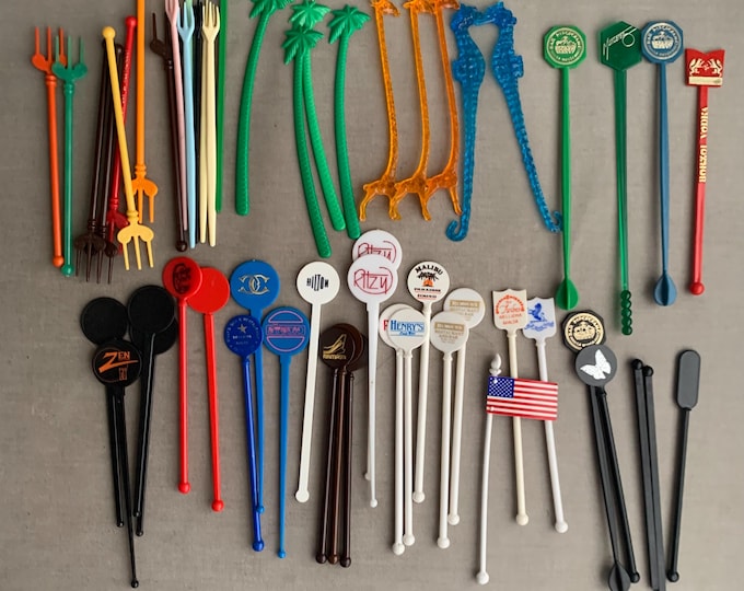 A large collection of vintage cocktail swizzel sticks