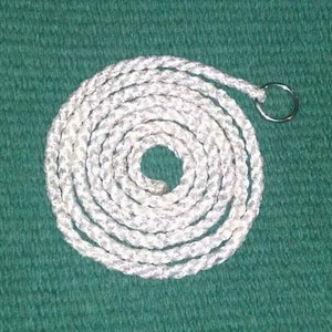 May include: White braided rope with a silver metal ring at the end. The rope is coiled in a circle.
