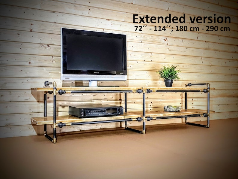 May include: A black metal and wood TV stand with two shelves. The stand is 72" - 114" (180 cm - 290 cm) long. The stand has a black TV on the top shelf and a black DVD player on the bottom shelf.
